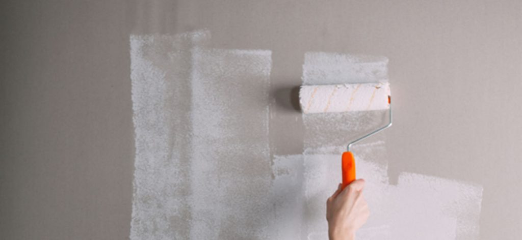 painting a wall with a roller