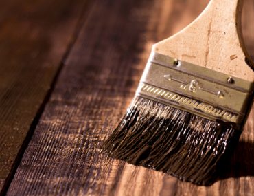 applying wood finish on wood with brush