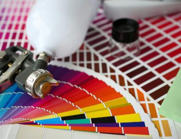 A paint sprayer with color sheets around it