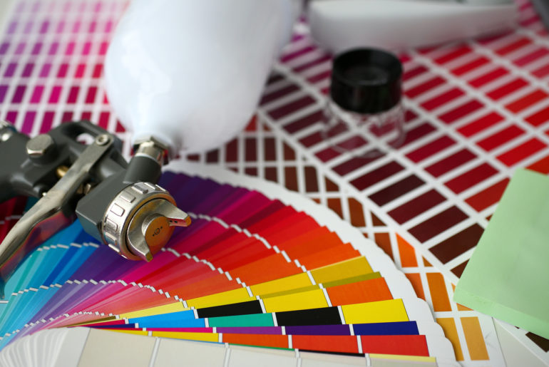 A paint sprayer with color sheets around it